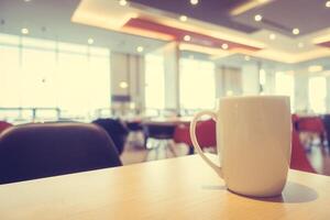 Coffee cup on table in restaurant photo