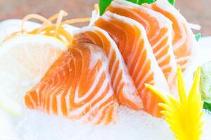 Salmon on ice with lemon and cucumber photo