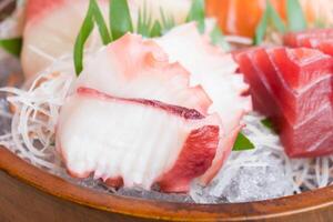 Sashimi in a bowl with a wooden bowl photo