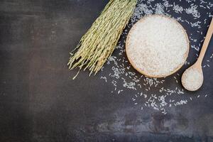 Rice and a spoon on a black background photo