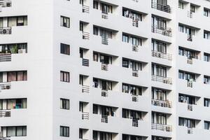 White apartment building with balconies and windows photo