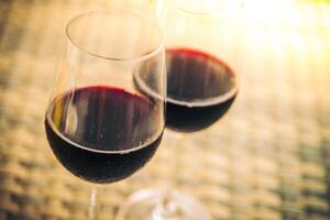Two glasses of red wine on a table photo