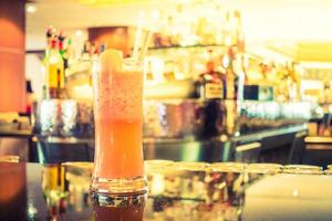 A drink sitting on a bar counter photo