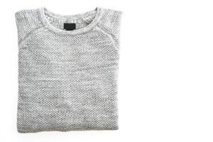 A gray sweater on a white surface photo