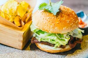 A hamburger with lettuce, tomato and cheese on a plate photo