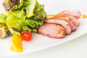 A plate of food with a salad and meat photo