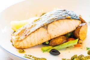 A plate of food with a piece of fish on it photo