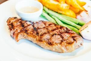 A plate of food with a side of vegetables photo