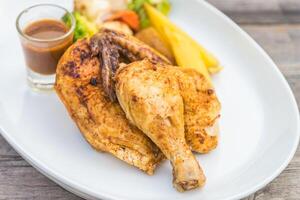 A plate with chicken and vegetables on it photo