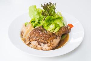 A plate with chicken, lettuce and vegetables photo