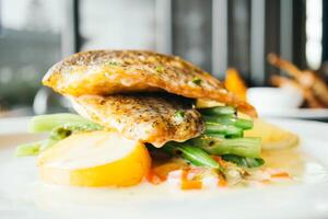 A plate with fish and vegetables on it photo