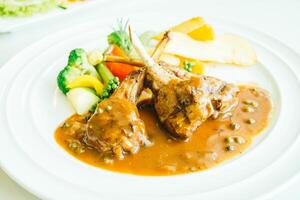 A plate of food with meat and vegetables on it photo