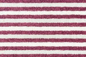 A rug with a striped pattern in burgundy and white photo