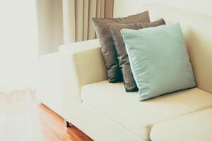 A white couch with two pillows on it photo