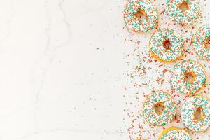 A white marble surface with a bunch of colorful sprinkles photo