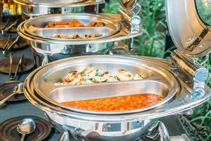 Buffet food with bowls of food on a table photo