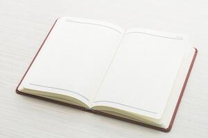 Open notebook on white table with copy space photo