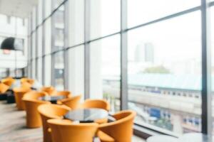 Orange chairs and tables in a hotel lobby photo