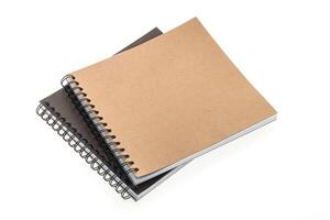 A notebook with a spiral notebook on top of it photo