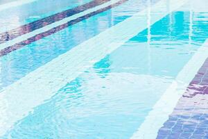 A person is standing in the middle of a swimming pool photo