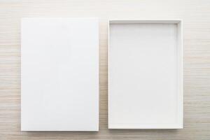 An empty white box on a wooden surface photo
