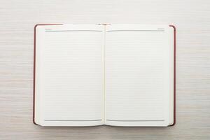 An open notebook with blank pages on a wooden surface photo