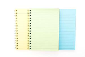 Three notebooks with different colors on a white background photo