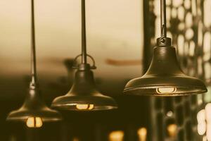 Three light bulbs hanging from a ceiling photo