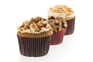 Three cupcakes with different toppings on them photo