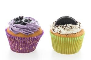 Two cupcakes with frosting and oreo cookies photo