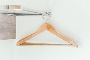 A wooden hanger hangs on a wall photo
