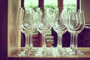 A row of empty wine glasses on a table photo