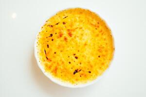 A white plate with a bowl of food photo