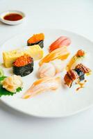 A white plate with a variety of sushi on it photo
