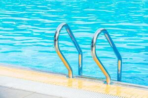 A pool with a ladder and a ladder to the edge photo