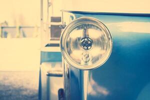 A close up of a blue bus with a light on it photo