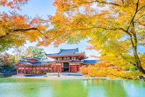 The asian temple is surrounded by colorful trees photo
