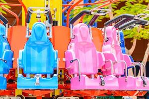 A row of colorful seats on a carnival ride photo