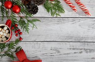 Christmas card with toys, fir branches and a garland.Decor with sweets, cinnamon. photo