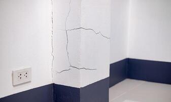 Wall Cracked, Concrete wall broken inside house, cement corner that effected with earthquake or collapsed ground, Construction problems from using poor quality materials or substandard craftsmanship photo