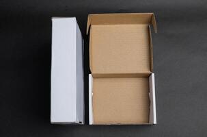 Two boxes sitting side by side one is closed and the other is open photo