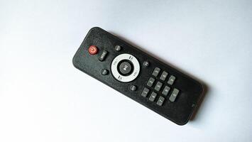 Black remote control on white background photo