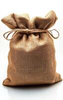 A brown bag with a white background. The bag is made of burlap and has a white string tied around it photo