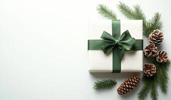 A white box with a green bow sits on a table with pine cones and twigs. Concept of warmth and holiday cheer, as the pine cones and twigs are often associated with Christmas photo