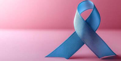 Light blue ribbon for awareness, support. A light blue ribbon stands against a soft pink background, representing awareness and support for various causes. photo