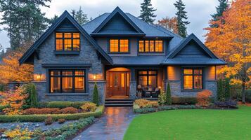 A large house with a large front porch and a large yard. The house is surrounded by trees and has a lot of windows photo