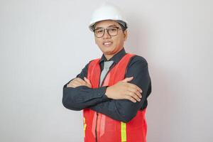 A handsome male engineer or architect with a white helmet on a white background standing in a photo studio. happy smiling worker
