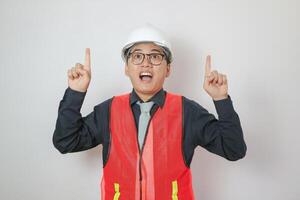 confident, professional asian man pointing finger up, concept of male engineer, civil construction worker, builder, architect, mechanic, electrician pointing finger at blank space photo