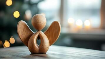 A wooden angel is sitting on a table. The angel has a heart on its chest and is surrounded by candles. The candles are lit, creating a warm and cozy atmosphere. Concept of peace and spirituality photo