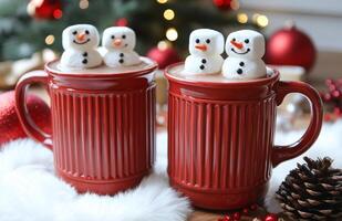 Two red cups with marshmallows on top of them. The cups are decorated with snowmen photo